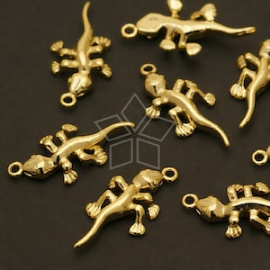 May include: A set of ten gold-toned metal lizard charms. Each charm features a detailed lizard design with a loop for attaching to jewelry or other crafts.