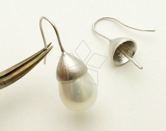 May include: A pair of silver earrings with a teardrop-shaped pearl pendant. The earrings have a simple, elegant design and are perfect for everyday wear.