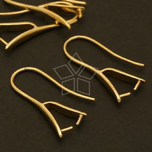 May include: Gold-toned earring hooks with a flat, slightly curved design. The hooks have a small loop at the top and a small hole at the bottom for attaching jewellery findings.