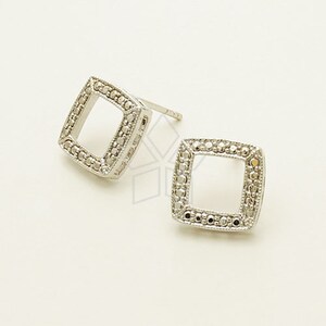 May include: A pair of silver square stud earrings with a beaded border.