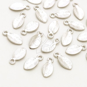 May include: A group of silver leaf-shaped charms with a loop at the top for attaching to jewelry or other crafts.