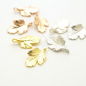 May include: Assortment of gold, silver, and rose gold leaf charms. Each charm features a detailed leaf design with a small loop for attaching to jewelry or other crafts.
