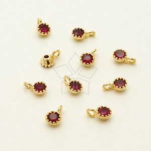 May include: Ten gold-tone charms with red rhinestone accents. Each charm features a small loop for attaching to jewelry.