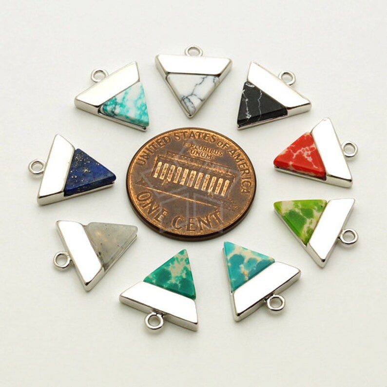 May include: A collection of triangular gemstone pendants with silver-colored metal accents. The pendants feature various colors and patterns, including turquoise, white, black, red, green, and blue. Each pendant has a small loop for attaching to a chain or other jewelry.