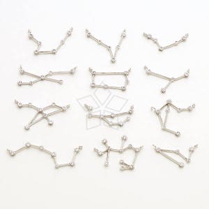 May include: Twelve silver charm pendants in the shape of constellations. Each pendant features small clear rhinestones.