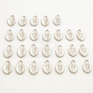 May include: A set of 26 silver leaf charms with each letter of the alphabet. The charms are all the same size and shape, and they are arranged in alphabetical order.