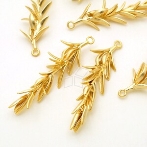 May include: Gold-toned metal olive branch charms with a loop for attaching to jewelry or other crafts.