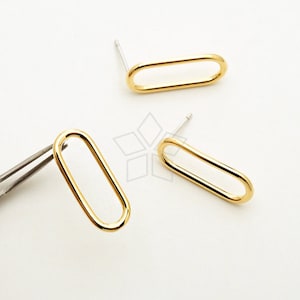 May include: A pair of gold oval-shaped earrings with a post back closure.