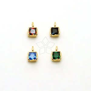 May include: Four gold-toned pendant charms with square-shaped, faceted gemstones. The charms feature red, black, blue, and green gemstones.