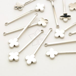 May include: A collection of silver-colored metal jewelry findings. Each finding features a clover-shaped charm attached to a straight bar with a small loop at the end. These components are ideal for creating earrings, necklaces, or other jewelry designs.