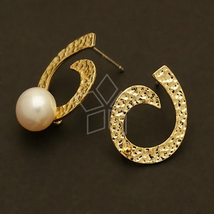May include: A pair of gold earrings with a hammered texture. Each earring features a circular design with a smaller circle inside. One earring has a white pearl attached to the outer circle.