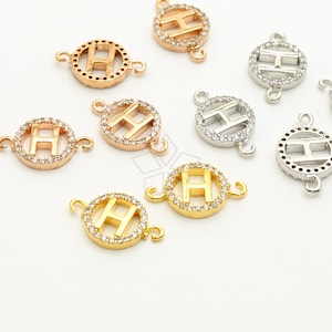 May include: Assortment of gold, silver, and rose gold tone metal charms featuring the letter H encrusted with clear rhinestones. Each charm has a circular design with two jump rings for attaching to jewelry.