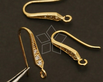 May include: Gold-tone earring hooks with clear crystal accents. The hooks are designed with a slight curve and a small loop at the end.