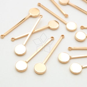 May include: Gold-toned metal craft supplies featuring round discs and straight rods with loops at each end.
