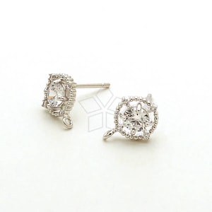 May include: A pair of silver earring findings with a clear crystal stone in a decorative setting. The findings have a loop for attaching a dangle charm.