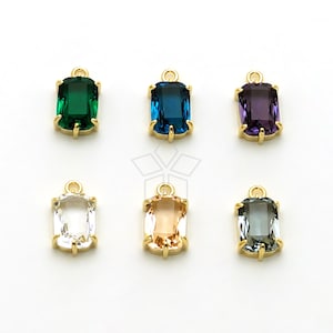 May include: Six gold-tone pendant charms with different colored faceted glass stones. The stones are emerald green, blue, purple, clear, light peach, and gray.