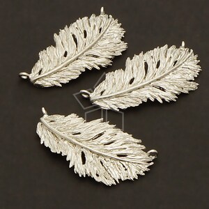 May include: Three silver feather charms with a detailed design. Each charm has two holes for attaching to jewellery.