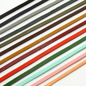 May include: Assortment of 12 leather cords in various colors, including black, navy, gray, green, brown, orange, red, pink, and light blue. The cords are arranged in a row, with the darkest colors at the top and the lightest colors at the bottom.