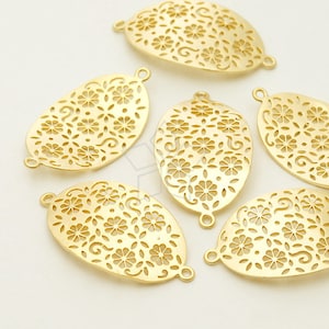 May include: Five gold oval-shaped metal charms with a delicate floral pattern. Each charm has two small loops at the top.