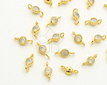 May include: A collection of gold-toned metal connector charms with clear opal-like stones. Each charm has two loops for attaching to jewelry.