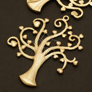 May include: Gold-toned metal tree charm with a detailed, textured trunk and branches adorned with heart-shaped leaves.