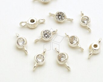 May include: Ten silver-toned connector charms with clear crystal accents. Each charm has two loops for attaching to jewelry.