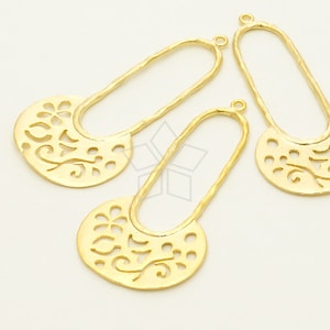 May include: Three gold-tone metal earring blanks with a decorative cutout design. The blanks are oval shaped with a small loop at the top for attaching earring hooks.
