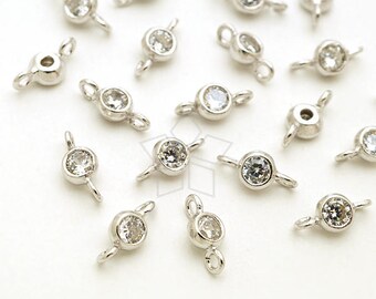 May include: A collection of silver-toned metal connector charms with clear crystal accents. Each charm has two loops for attaching to jewelry.