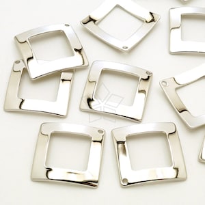 May include: A collection of shiny, silver-colored square-shaped jewelry components. Each component has a rounded square shape with a hole in each corner. The components are reflective and appear to be made of metal.