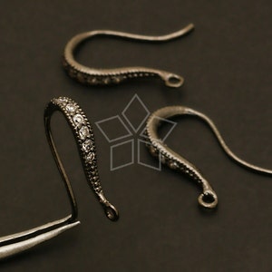 May include: Three black metal earring hooks with clear rhinestone accents. The hooks are curved and have a small loop at the end.