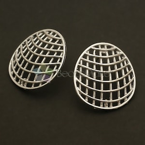 May include: A pair of silver earrings with a geometric design. The earrings are round and have a grid pattern.