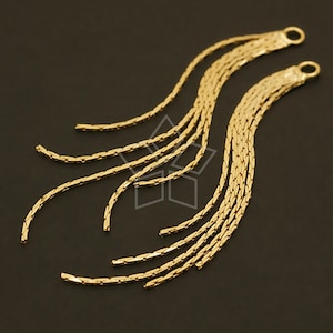 May include: Two gold chain tassels with a loop at the top. The chains are made of small, linked squares.