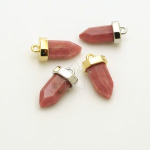 May include: Four pink gemstone pendants with gold and silver accents. The pendants are shaped like a pointed crystal and have a hole at the top for attaching to a necklace or bracelet.