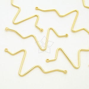 May include: Gold-toned metal star-shaped jump rings with two loops on each ring. The rings are arranged in a random pattern on a white surface.