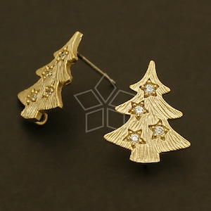 May include: A pair of gold-tone Christmas tree earrings with clear crystal accents.