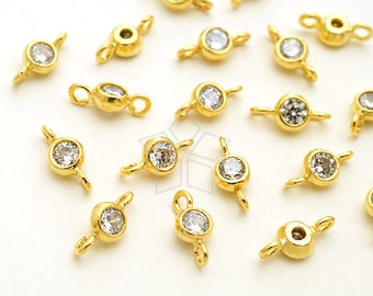 May include: A collection of gold-toned metal connector charms with clear crystal accents. Each charm has two loops for attaching to jewelry.