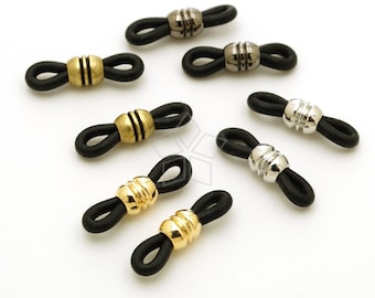 May include: Assortment of eight black rubber eyeglass strap holders with different colored metal accents. The accents include gold, silver, and gunmetal.