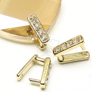 Puede incluir: Tres piezas de conexión de metal dorado con detalles de diamantes de imitación transparentes. Cada pieza tiene una forma rectangular con un pequeño bucle en un extremo.