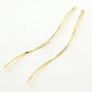 May include: Two gold-colored, twisted wire earring findings with a loop at the top.