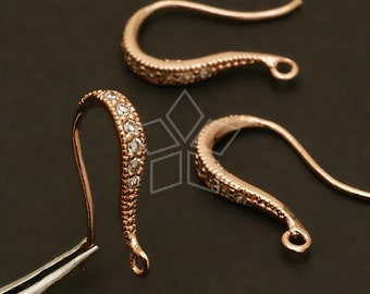 May include: Three rose gold earring hooks with clear crystal accents. The hooks are designed with a curved shape and a small loop at the end.