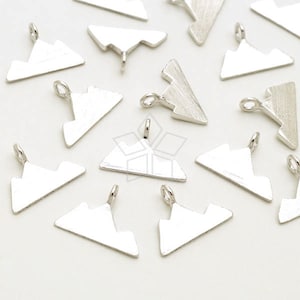 May include: A collection of silver-toned metal charms shaped like mountains. The charms have a hole at the top for attaching to jewelry or other crafts.