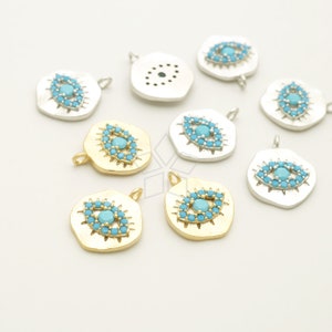 May include: Assortment of gold and silver evil eye charms with blue turquoise stones. The charms are in the shape of an eye with a circle of smaller stones around it. The charms are perfect for jewellery making or adding a touch of style to any project.