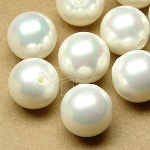 May include: A group of white pearl beads with an iridescent sheen. The beads are round and smooth, and they have a hole in the center for stringing.
