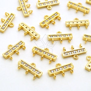 Puede incluir: Conectores de joyería rectangulares dorados con tres bucles y una fila de pequeños cristales transparentes. Los conectores tienen un pequeño bucle en la parte superior para la fijación. Ideal para la creación de joyas.