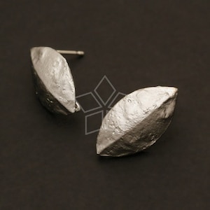 May include: A pair of silver earrings shaped like leaves with a textured surface.