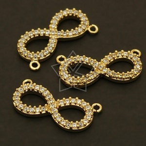 May include: Three gold infinity symbol charms with clear crystal accents. Each charm has a loop for attaching to a necklace or bracelet.