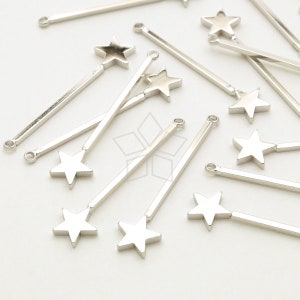 May include: A set of silver star-shaped charms attached to silver sticks. The charms are about 1 inch in diameter and the sticks are about 3 inches long.