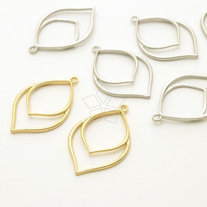 May include: Two gold and four silver double-layered leaf-shaped pendant charms with a loop at the top for attaching to jewelry.