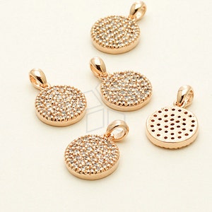 May include: Five gold-tone pendant charms. Four charms are round and feature a pave setting of clear rhinestones. One charm is round and features a geometric pattern of small holes.