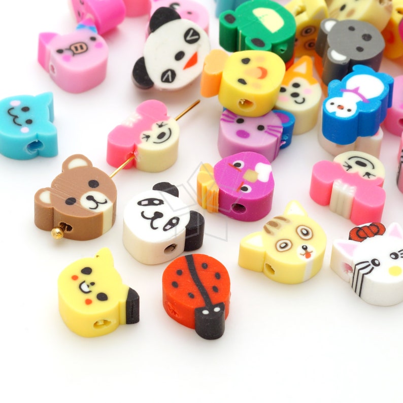 May include: Assortment of colorful plastic beads with various animal and insect designs. The beads have a hole through the center for stringing.